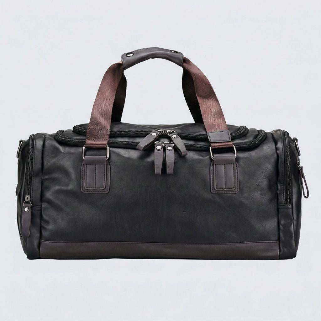 Vue frontale du Duffle Bag cabine noir, doubles tirettes centrales et sangles de maintien en simili cuir brun