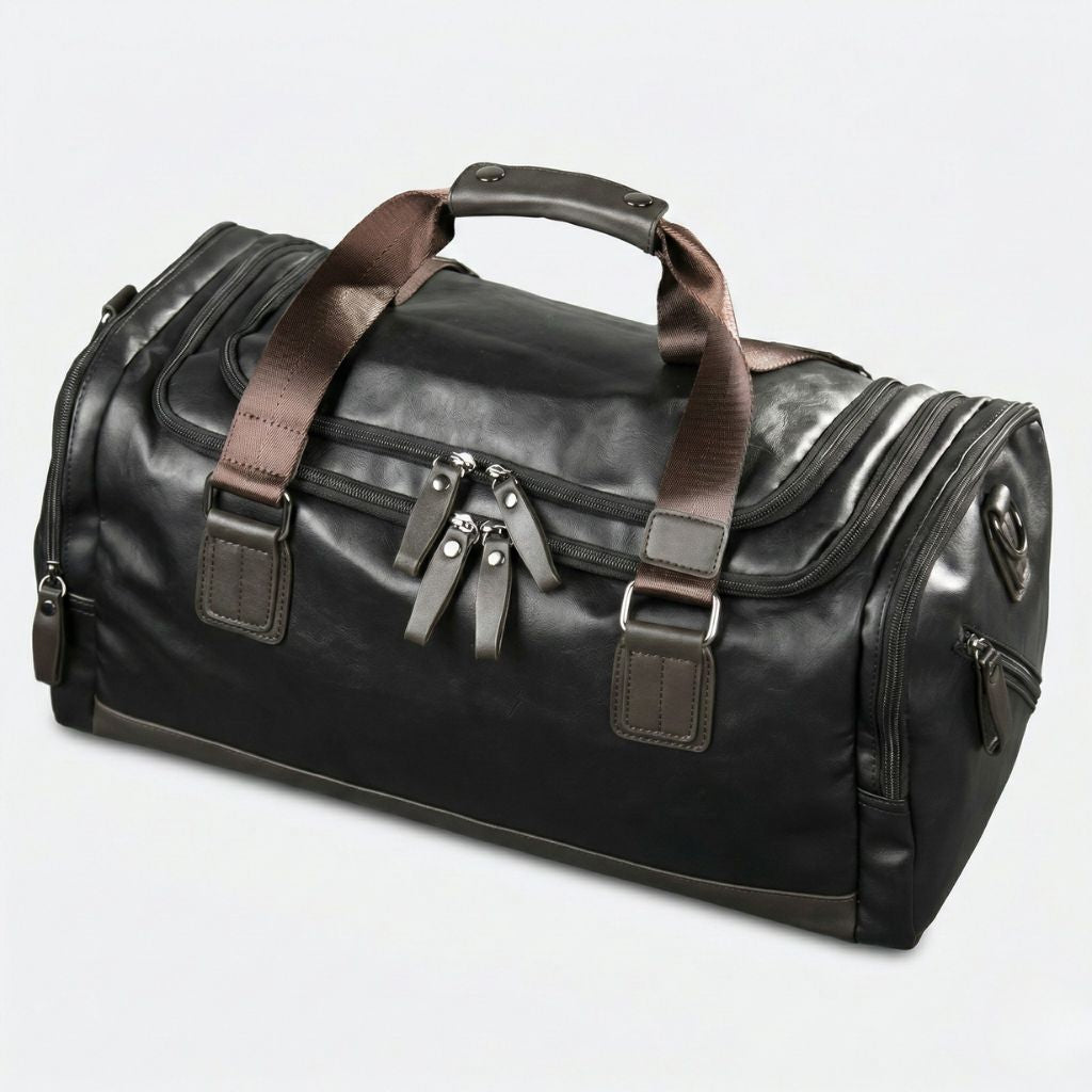 Dessus bombé du Duffle Bag cabine noir, doubles fermetures zippées visibles sur le dessus, simili cuir grainé