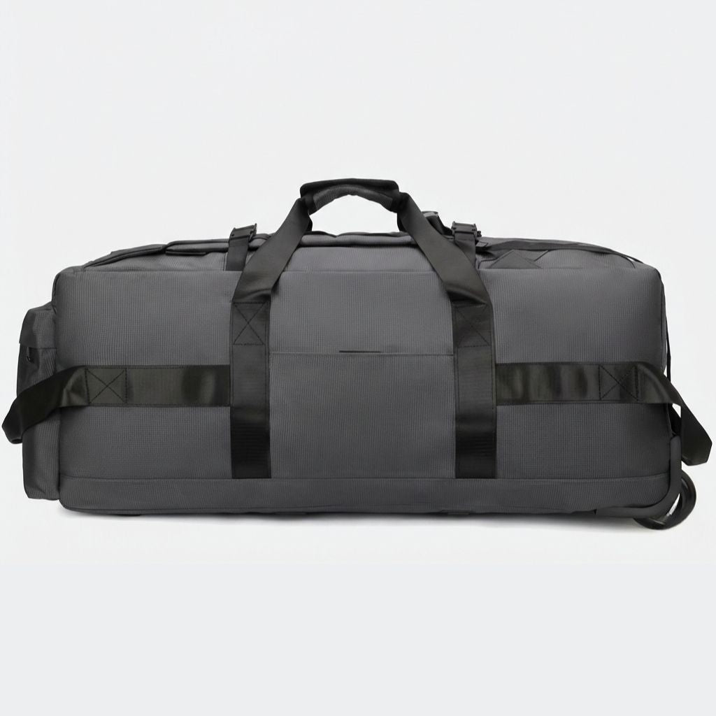 Face avant du sac gris anthracite en mode duffel : poignée supérieure rembourrée et poche frontale zippée