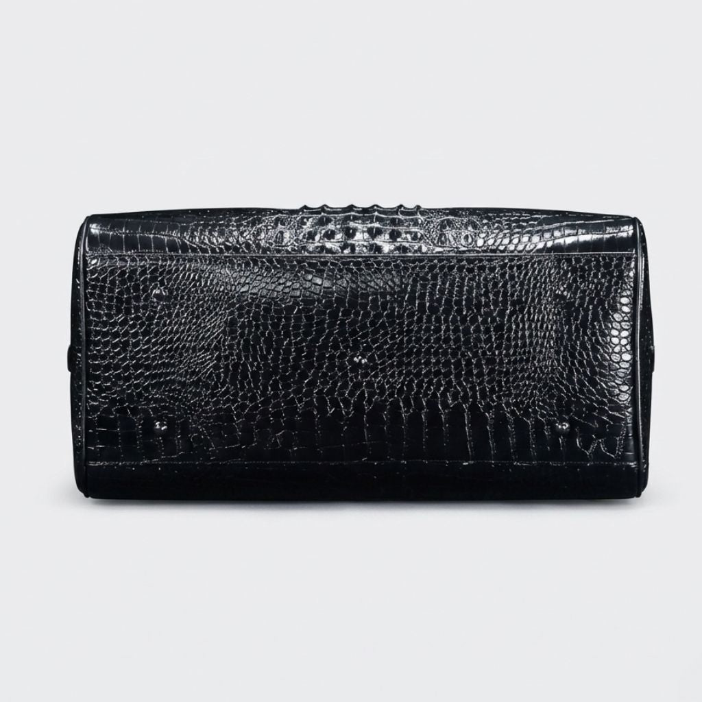 Dessous du sac de voyage cuir croco noir brillant avec quatre pieds protecteurs argentés antirayures