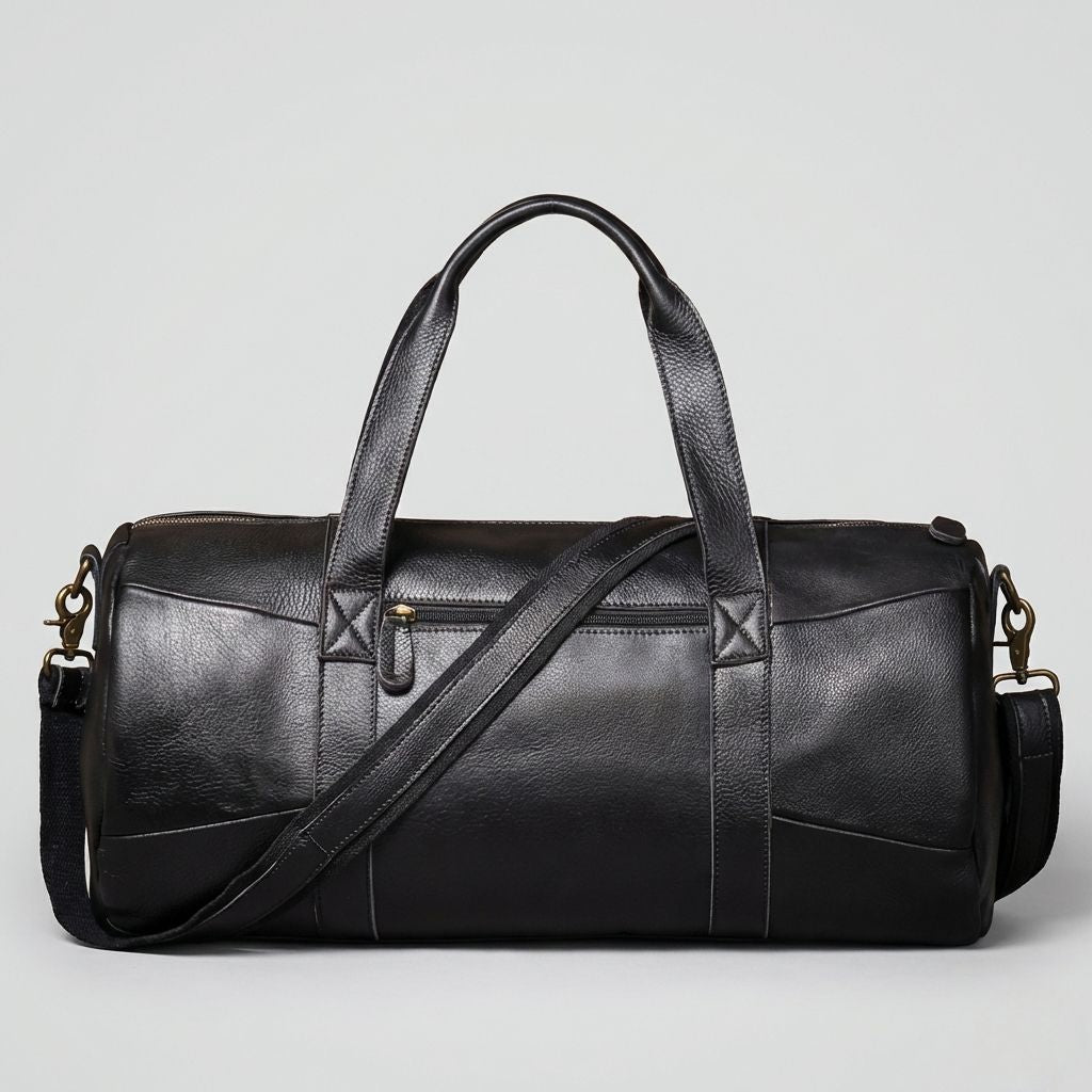 Sac de voyage en cuir noir mat format cabine, poche avant zippée, coutures en croix et ferrures laiton