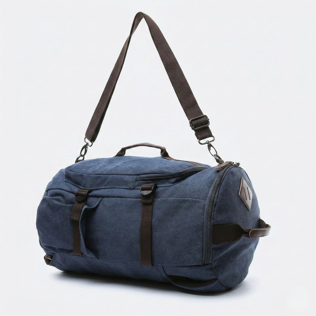Sac de voyage duffle bleu marine en mode polochon avec bandoulière longue réglable et finitions cuir marron