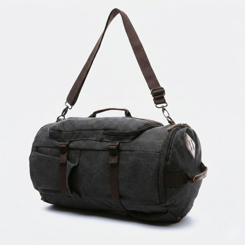 Sac de voyage duffle noir anthracite en mode polochon, bandoulière réglable, sangles de fixation et logo discret