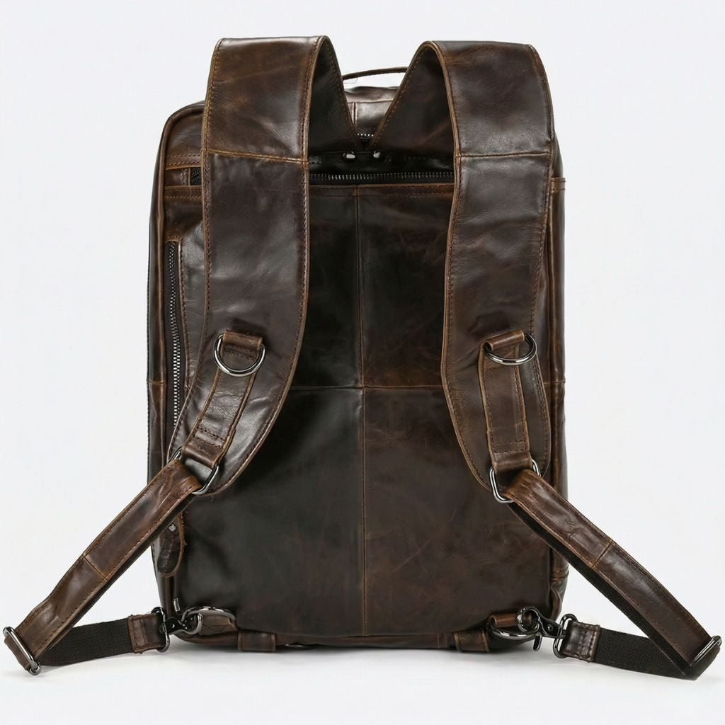Dos en mode sac à dos, bretelles larges cuir marron matelassé et sangles canvas noires à clips métal