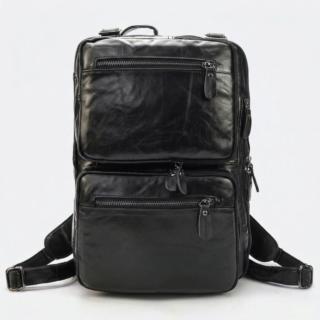 Sac noir en mode sac à dos, face avant avec bretelles larges déployées et deux poches horizontales zippées
