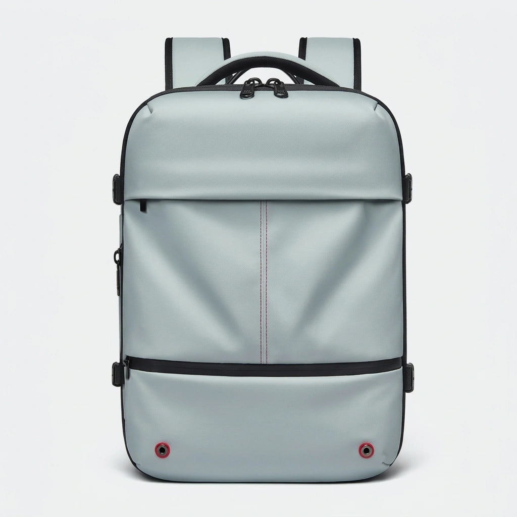 Sac à dos de voyage vert menthe vu de face avec surpiqûres centrales, sangles et œillets décoratifs rouges