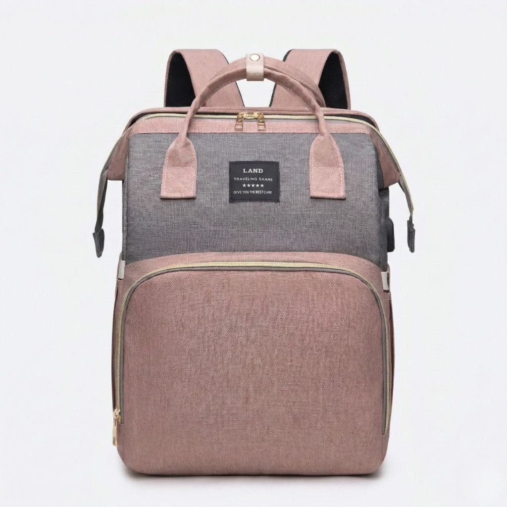 Sac à langer rose poudré et gris bicolore face avant : partie basse rose, haut gris, zips dorés