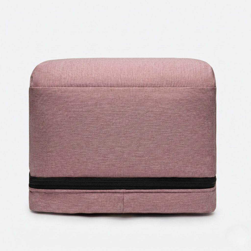 Vue de dessus du sac à langer rose poudré avec berceau intégré replié, silhouette rectangulaire compacte