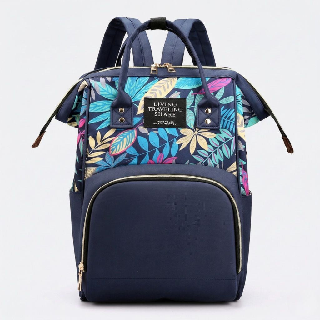 Sac à langer bleu marine à motif feuilles tropicales colorées, doubles poignées et fermeture éclair dorée