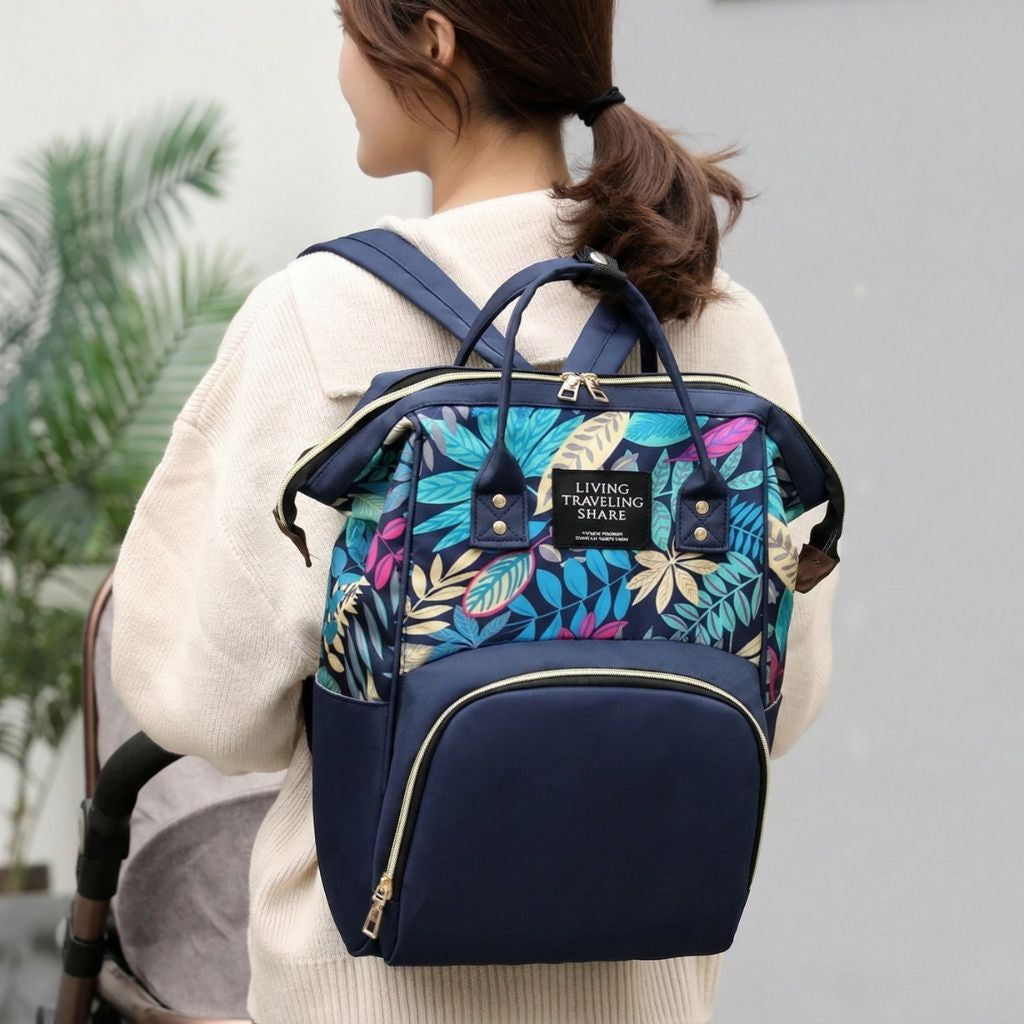 Femme portant le sac à langer bleu marine à motif feuilles tropicales sur le dos, style de vie en extérieur