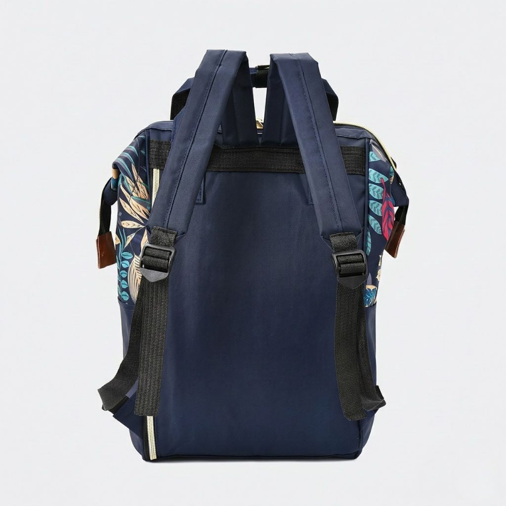 Vue arrière du sac à langer bleu marine, bretelles larges rembourrées noires, fermetures éclairs dorées