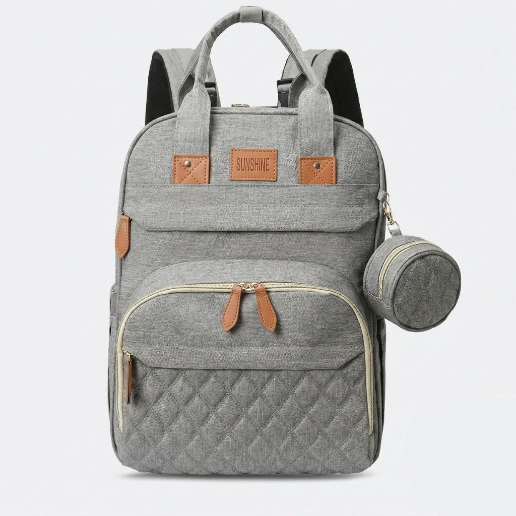 Sac à langer gris chiné avec compartiment isotherme ouvert montrant trois porte-biberons élastiques intégrés