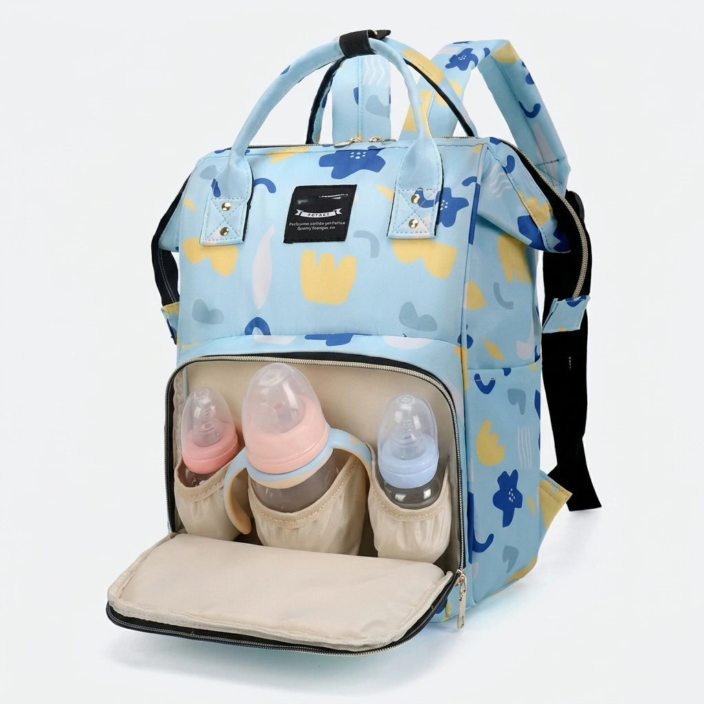 Sac à dos à langer bleu à motifs fleurs colorées ouvert avec compartiment avant contenant trois biberons rangés Image