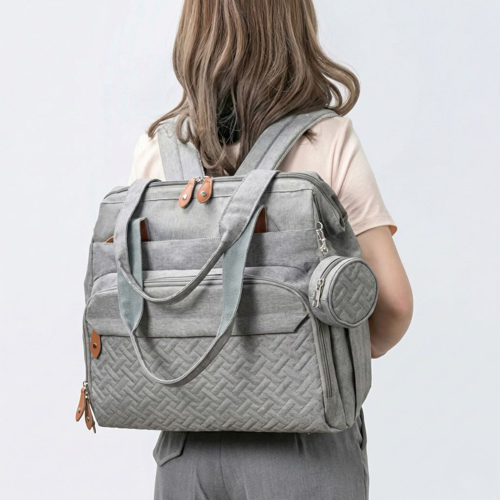 Lifestyle : femme portant le sac gris chiné en mode sac à dos vu de dos, bretelles ajustées