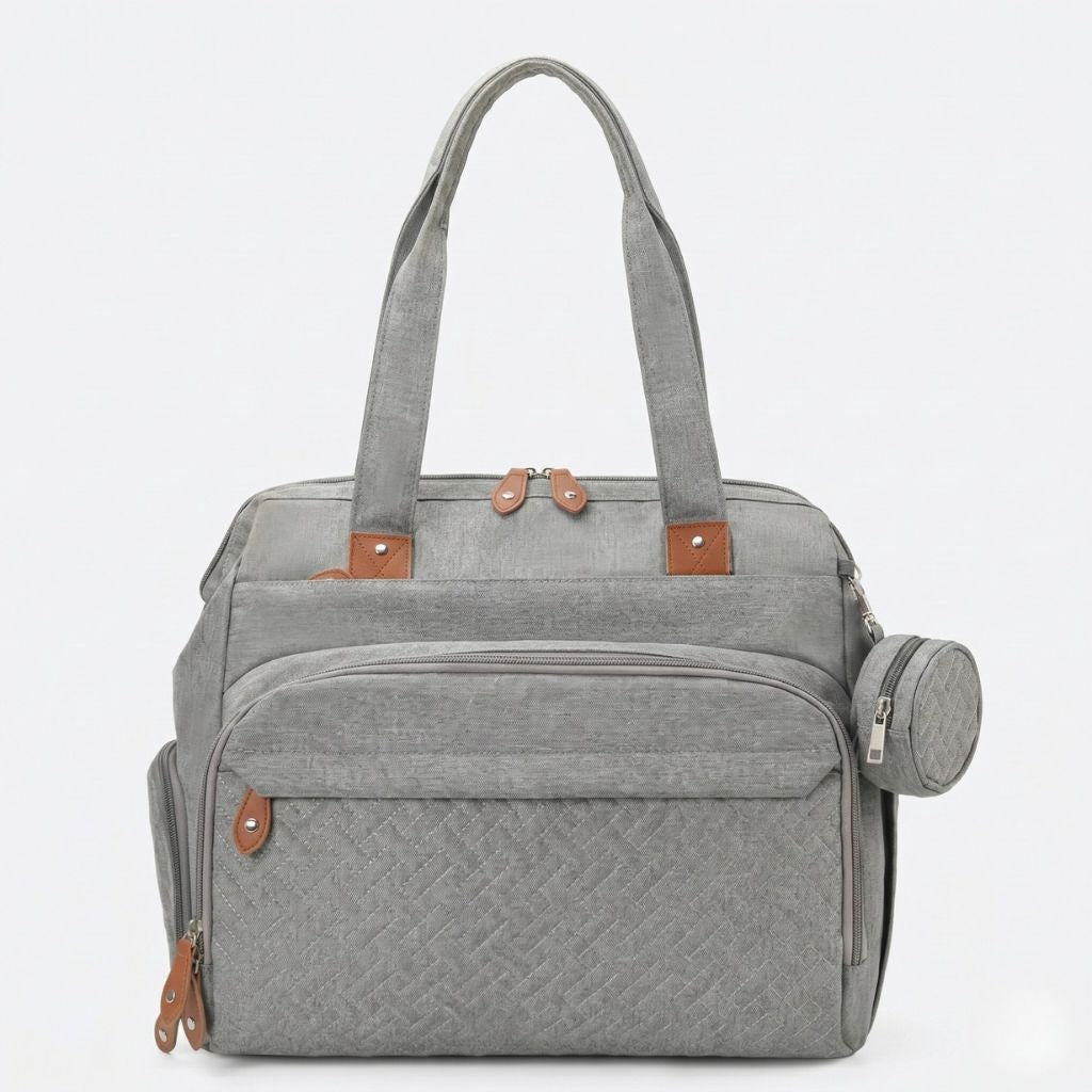 Sac gris chiné en mode tote bag face avant avec poignées longues, pochette ronde latérale et détails cuir fauve