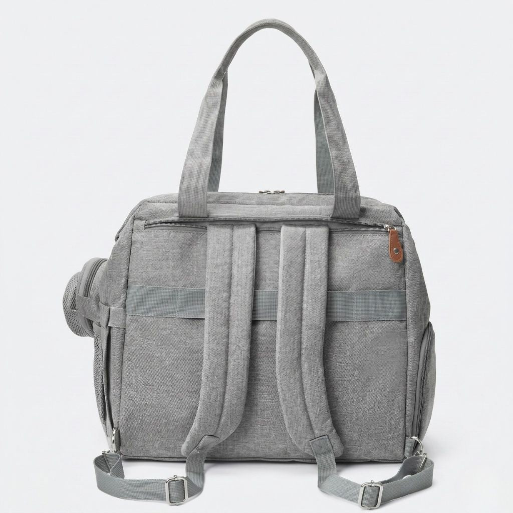 Dos du sac gris chiné avec bretelles maillées rembourrées déployées en mode sac à dos et passant trolley