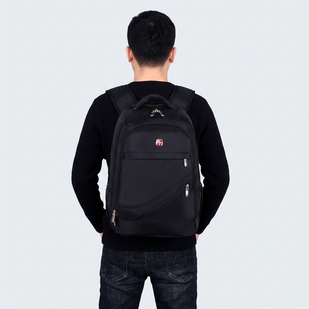 Homme portant un sac à dos noir en mode backpack, vue de dos, bretelles rembourrées ajustées sur le dos
