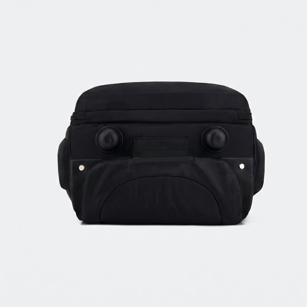 Dessous du sac à dos à roulettes noir avec deux roulettes sphériques pivotantes et patins de protection