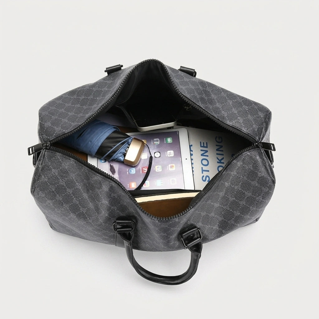 Sac de voyage homme gris à motif damier, vue du dessus ouvert révélant l'intérieur spacieux avec tablette et livre