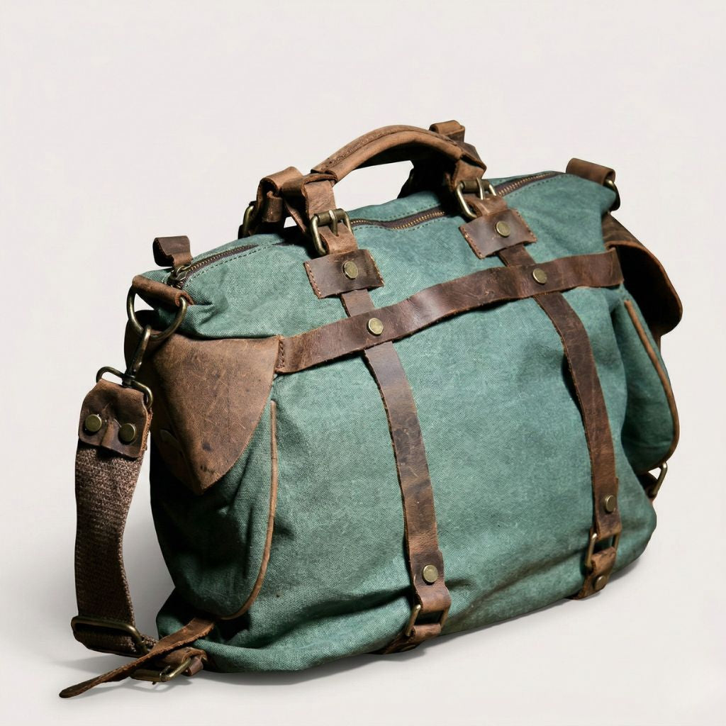 Sac de voyage vert forêt vue 3/4 : bandoulière cuir marron, zips cuir dorés, sangles croisées et poche latérale