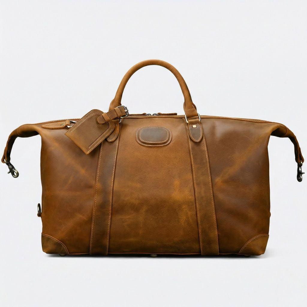 Sac de voyage cuir cognac doré, face avant avec sangles latérales rassemblées et quincaillerie argentée