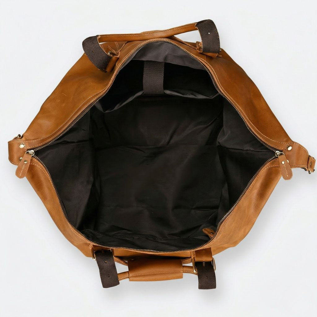 Vue aérienne de l'intérieur vide du sac, doublure nylon kaki foncé et sangles canvas des poignées visibles