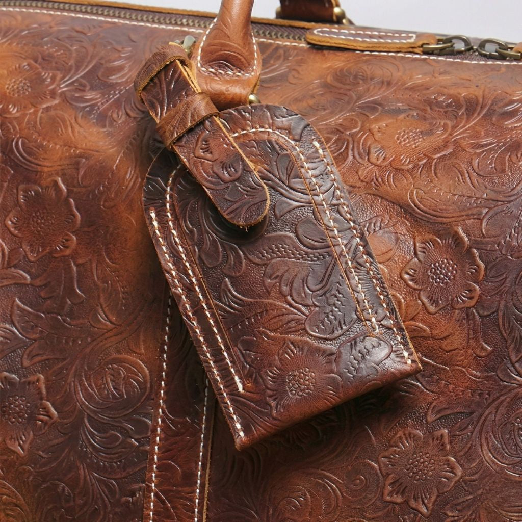 Étiquette bagage en cuir brun embossé motifs floraux assortie au sac de voyage format cabine