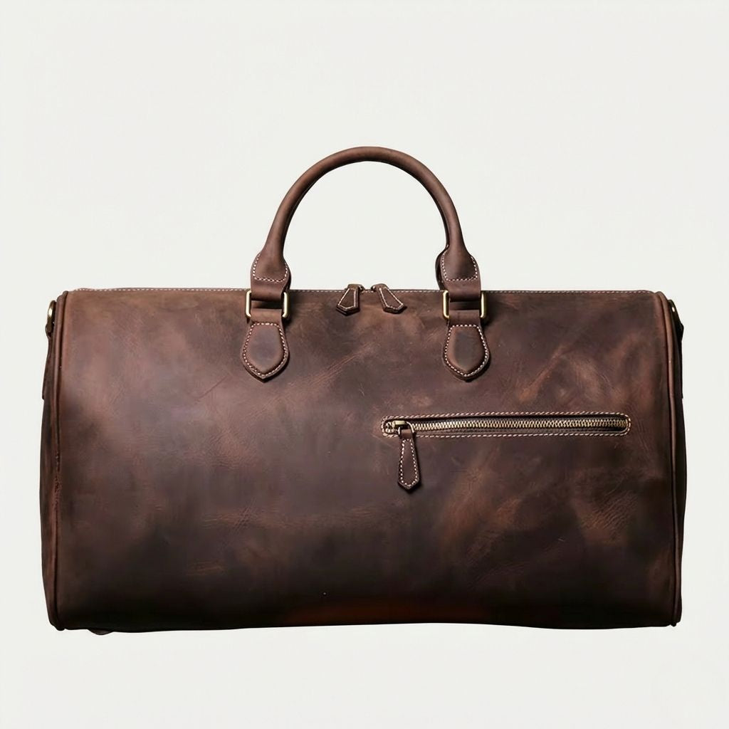 Face avant du sac de voyage cuir brun chocolat foncé, poche frontale zippée et double tirette laiton