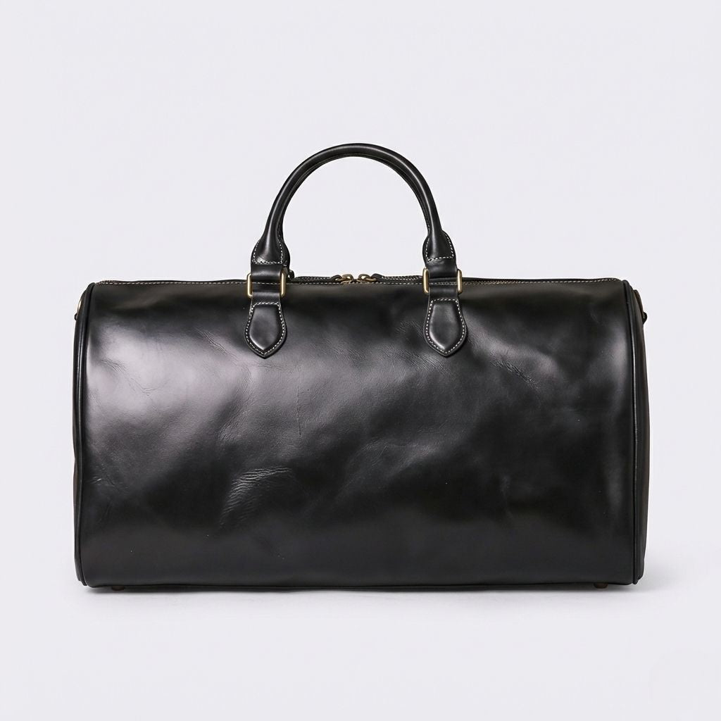 Dos du sac de voyage cabine en cuir noir lisse, profil épuré avec anneau D et surpiqûres blanches