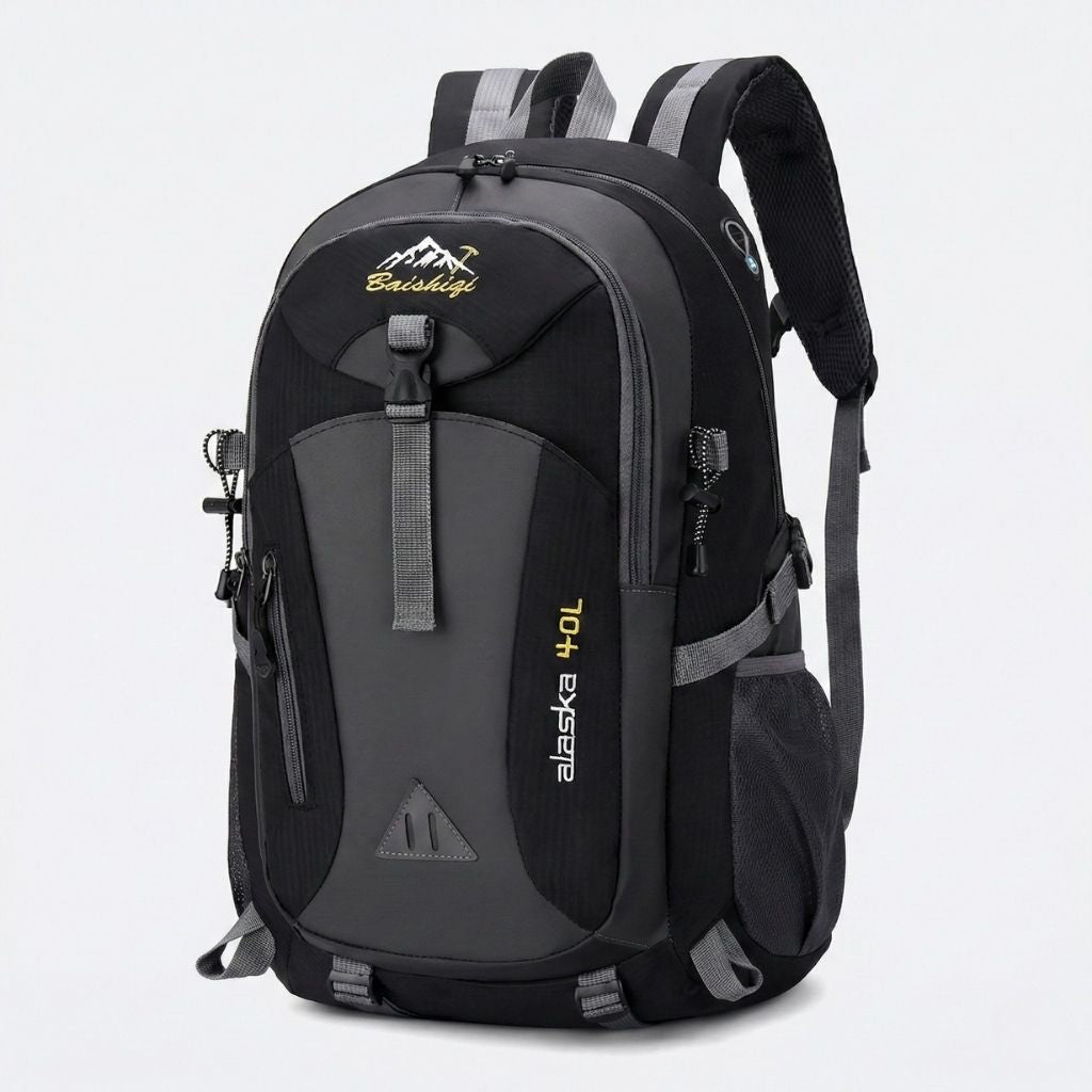 Sac à dos randonnée étanche 40L noir et gris, bretelles rembourrées et poches frontales zippées organisées.