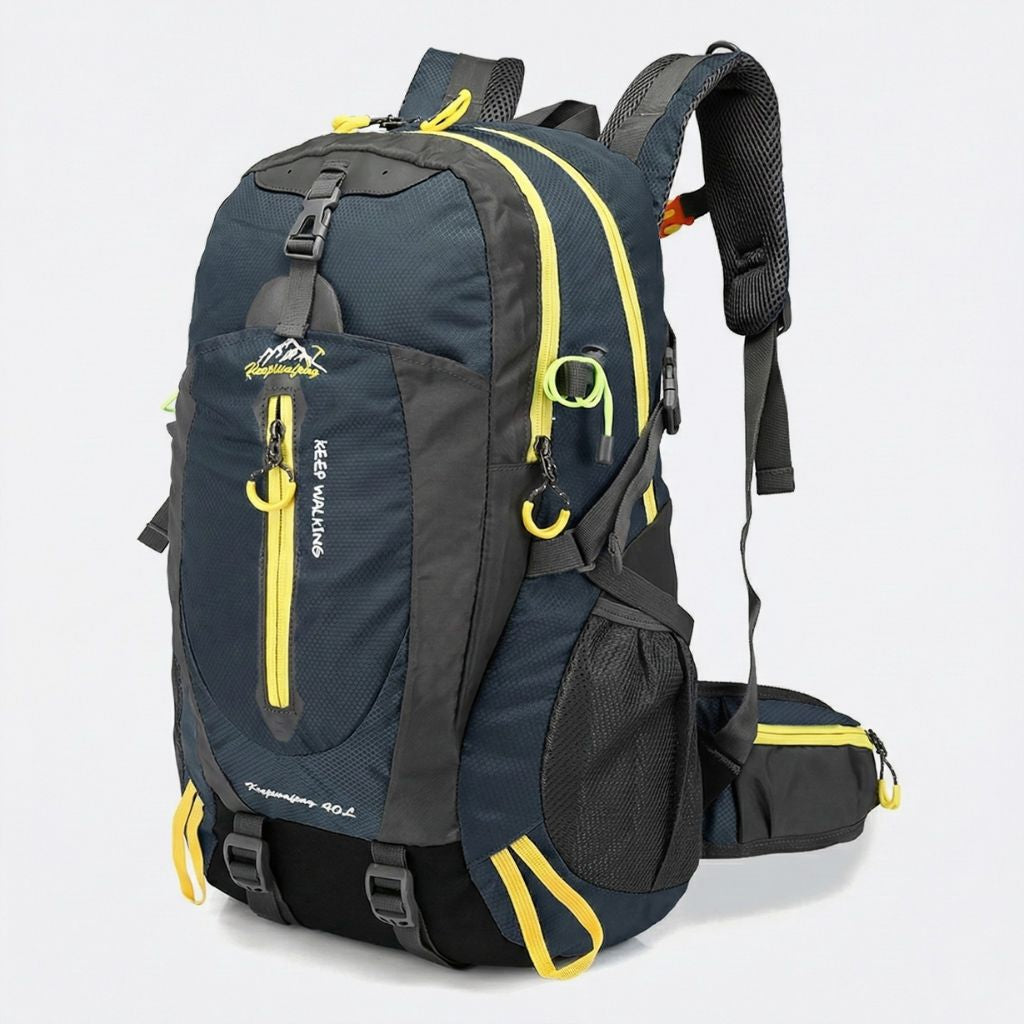 Sac à dos randonnée 40L bleu marine et gris, liserés jaune fluo, bretelles rembourrées et poches frontales.
