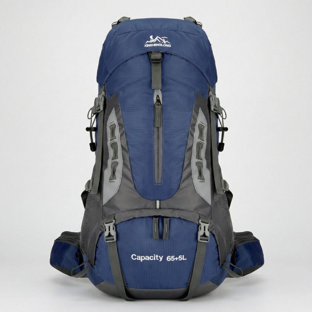 Sac à dos randonnée 70L bleu marine et gris, structure haute, poches frontales et ceinture lombaire rembourrée.