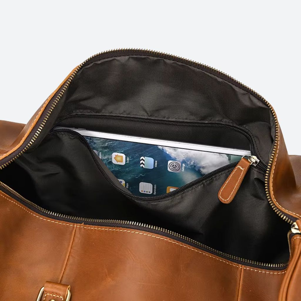 Poche intérieure zippée du sac cuir crazy horse cognac, gros plan avec une tablette insérée visible