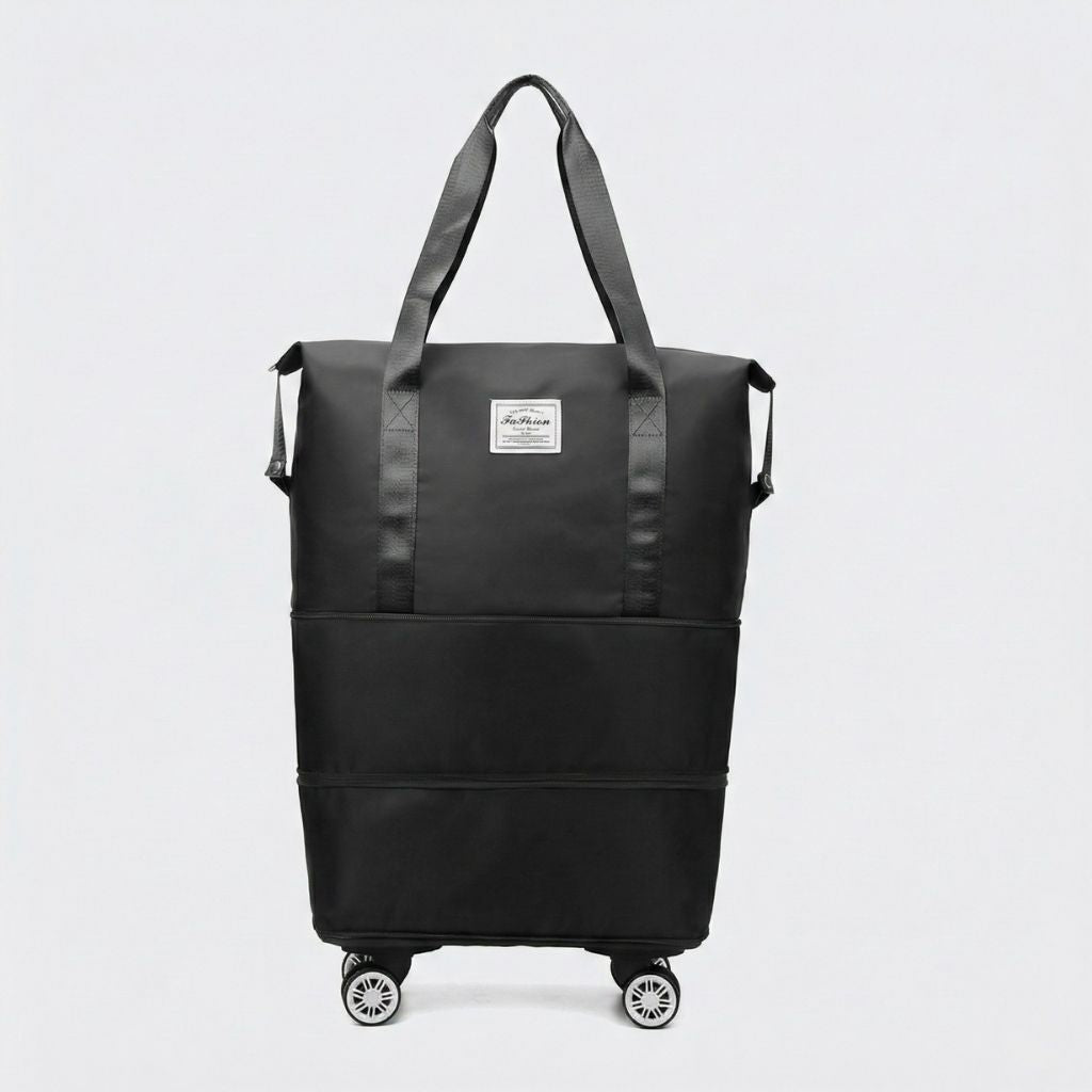 Sac de voyage femme extensible noir sur quatre roulettes amovibles, vue de face, deux anses et étiquette tissu