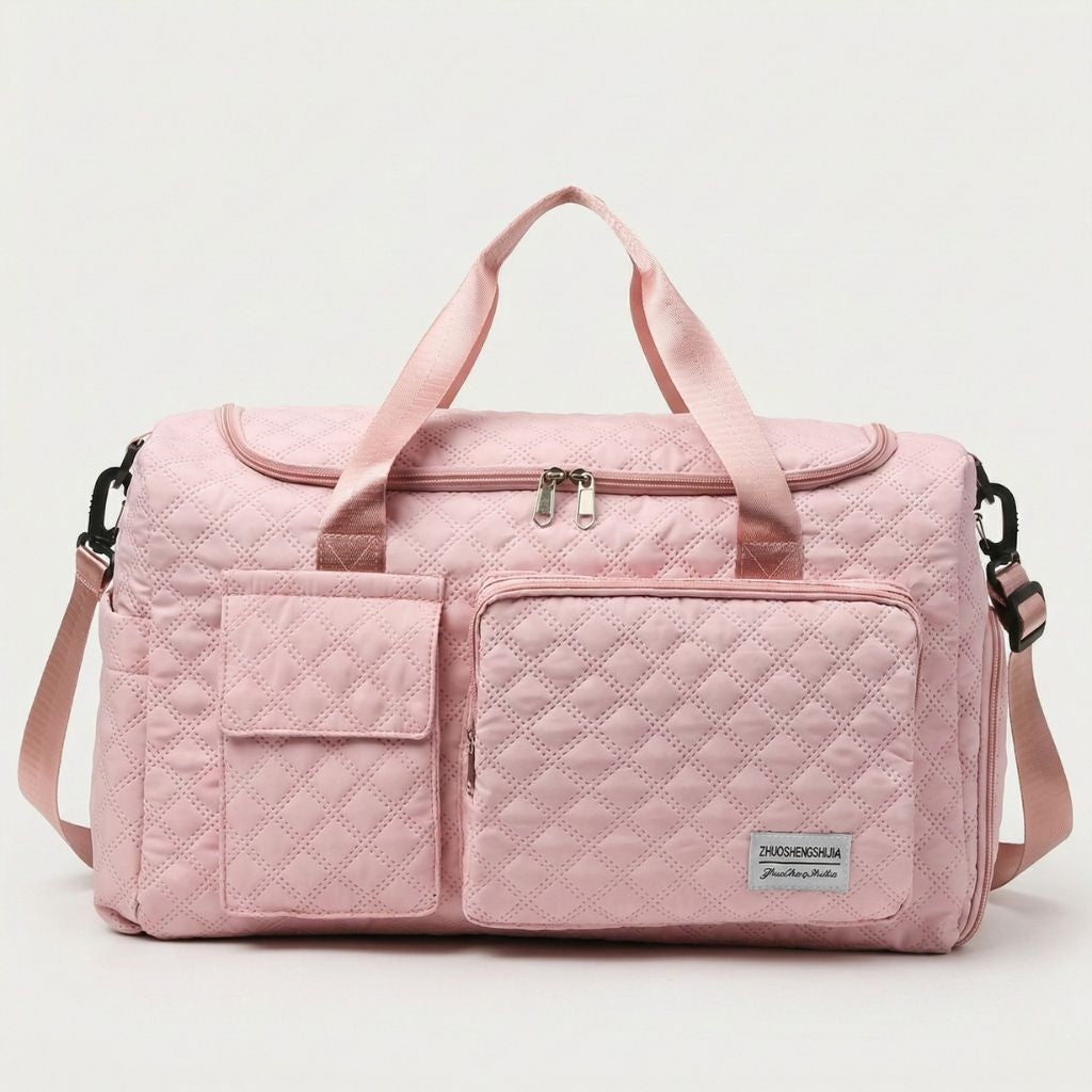 Sac de voyage femme cabine matelassé rose pâle, vue de face, poignées textiles et deux poches frontales zippées