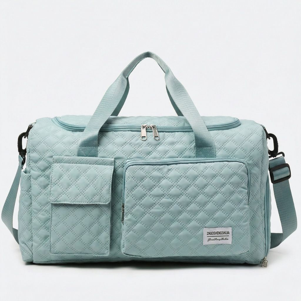 Sac de voyage femme cabine matelassé vert menthe, vue de face, deux poignées et poches frontales zippées losanges