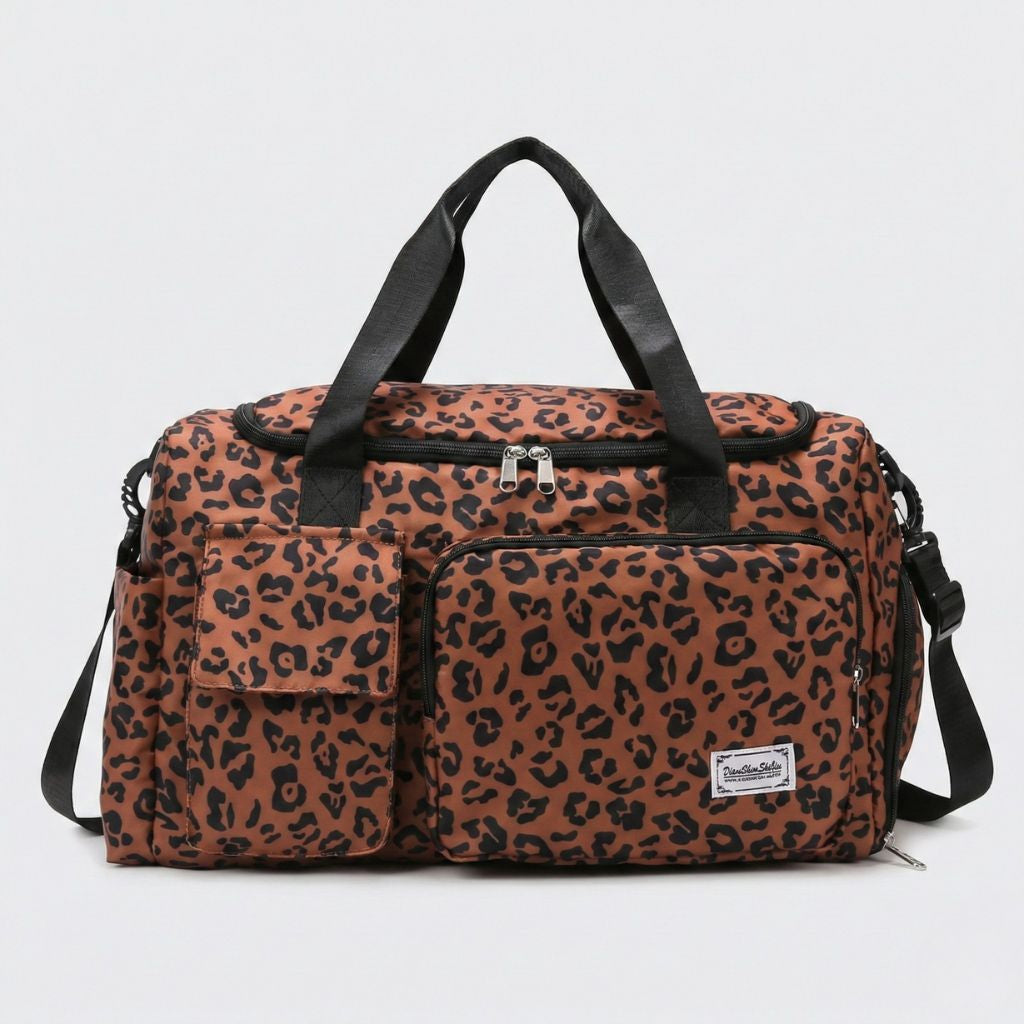 Sac de voyage femme en toile imprimé léopard marron caramel, vue de face, deux poignées noires et poche frontale
