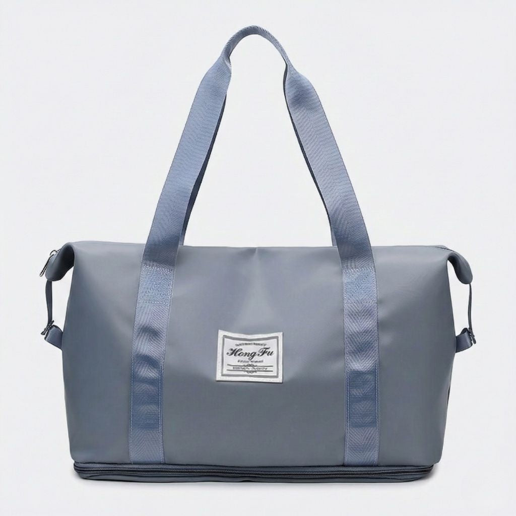 Sac de voyage femme gris bleuté, vue de face, poignées gris assortis et étiquette tissée, format cabine extensible