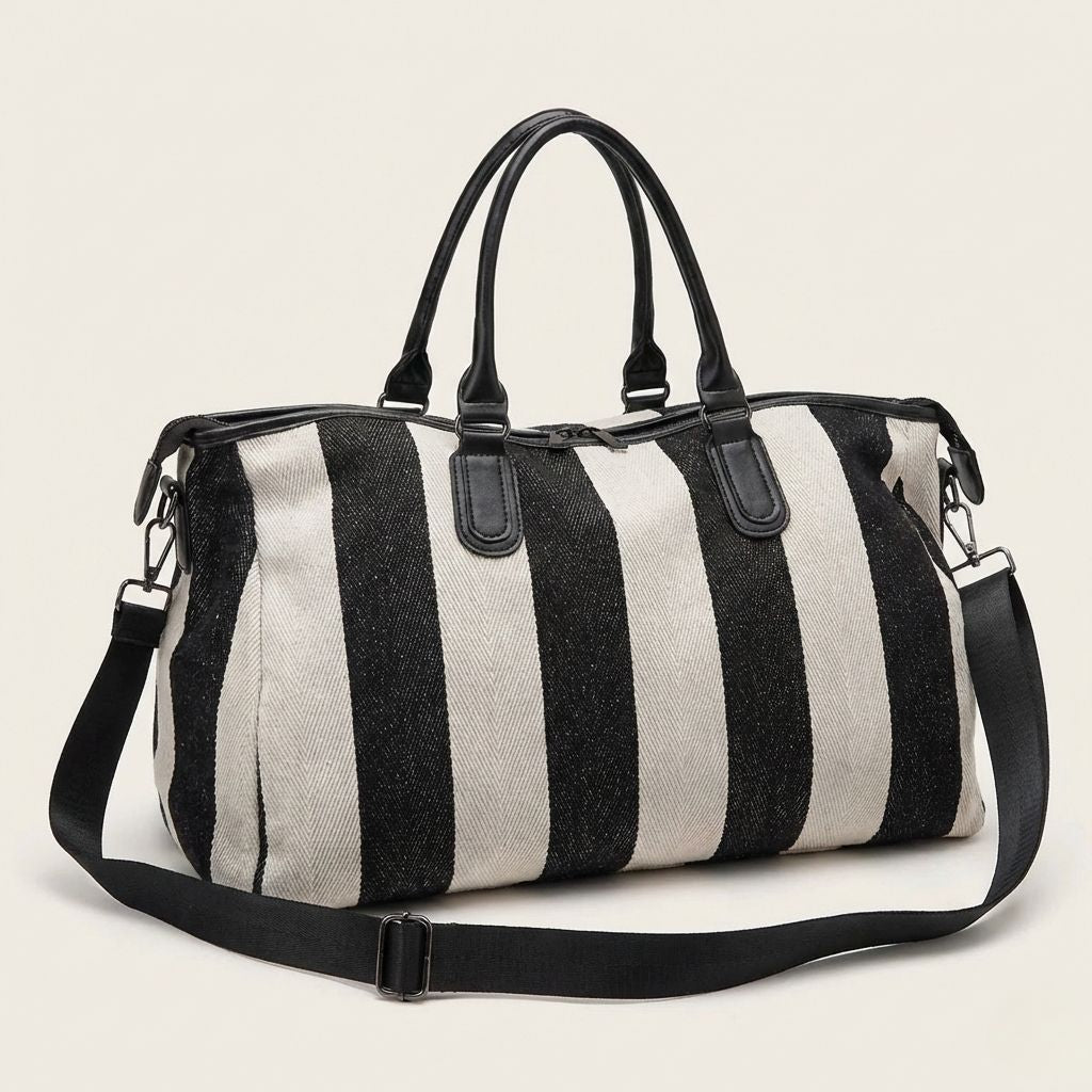 Sac de voyage cabine femme à larges rayures verticales noires et beige, doubles poignées et bandoulière noire