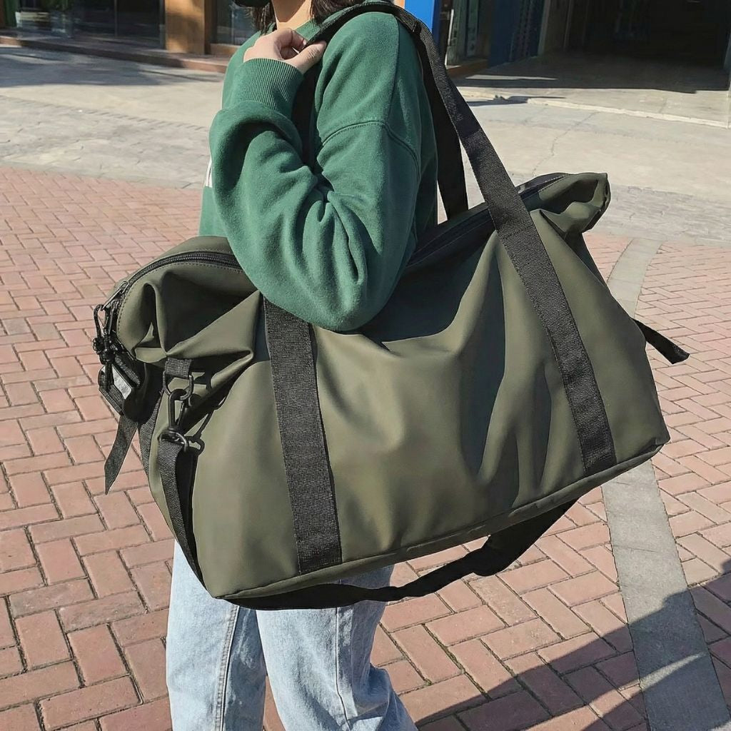 Personne portant sur l'épaule un sac de week-end en nylon vert kaki militaire avec bandoulière réglable Image