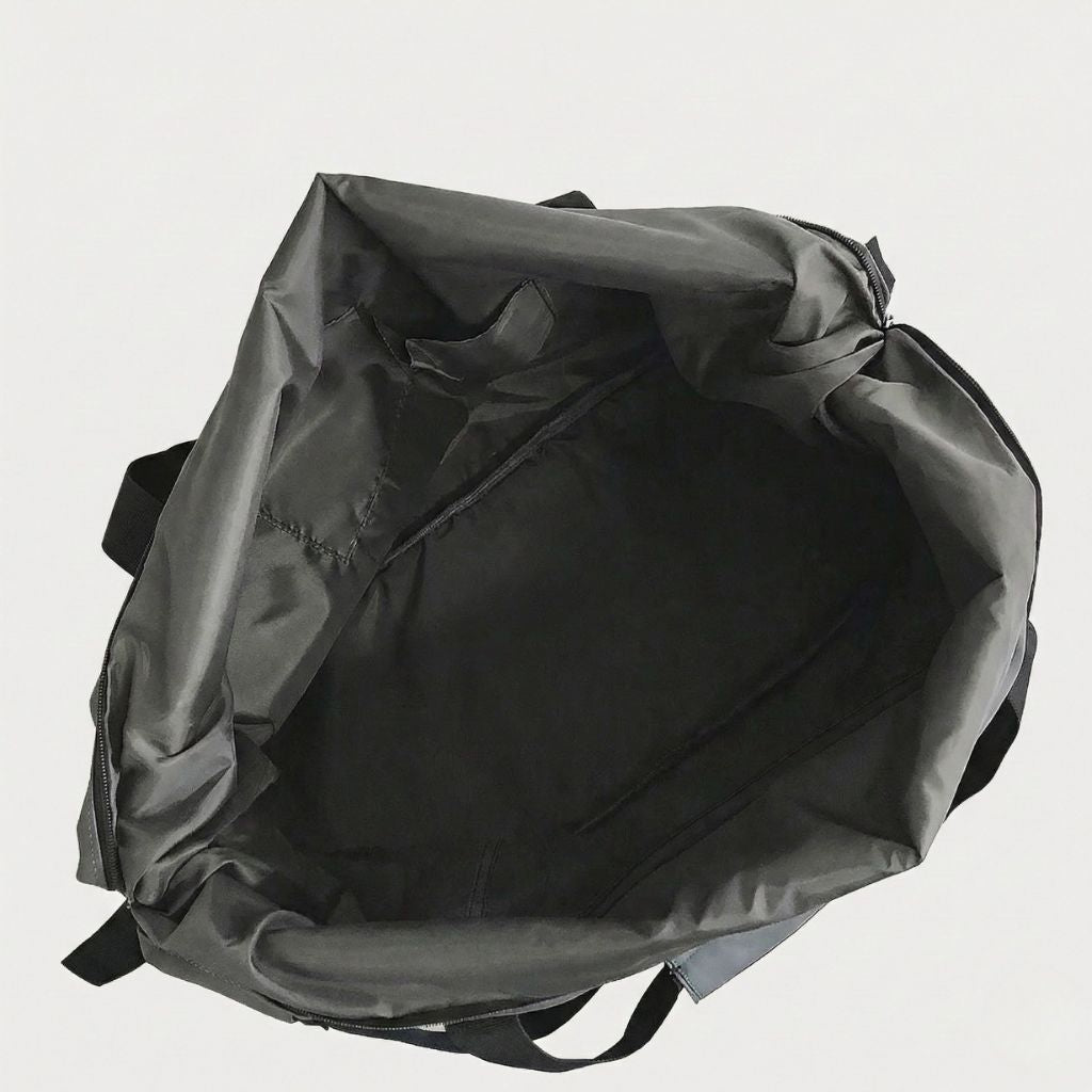 Intérieur du sac de voyage imperméable noir ouvert avec deux smartphones rangés dans la poche compartimentée