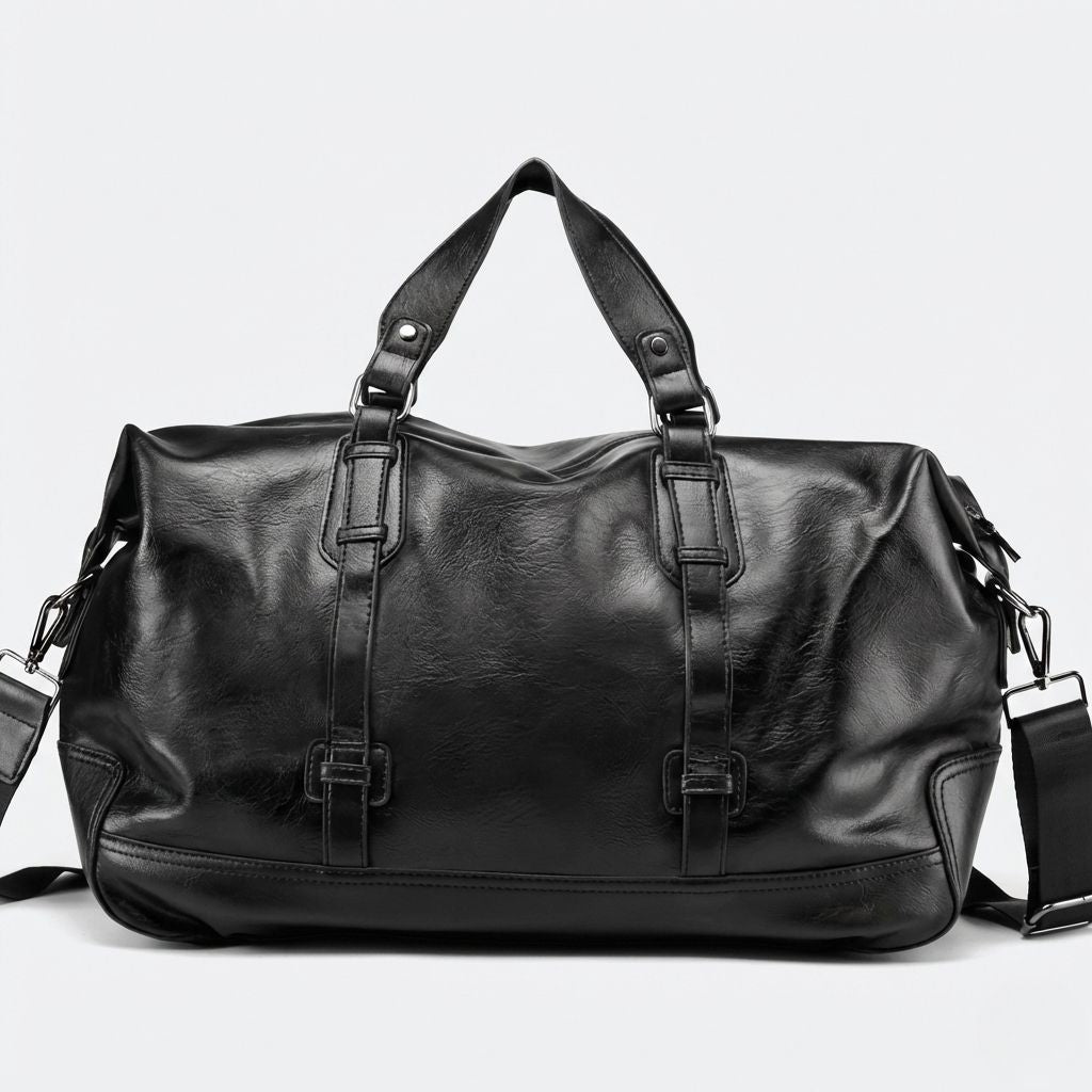 Face avant du sac de voyage noir cabine, matière simili-cuir souple et sangles de maintien centrales